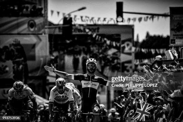 Colombia's Fernando Gaviria celebrates as he crosses the finish line ahead of Slovakia's Peter Sagan and Germany's Marcel Kittel to win the first...