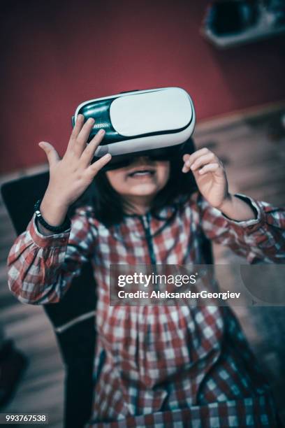 kid enjoying watching videos with virtual reality set - human body part videos stock pictures, royalty-free photos & images