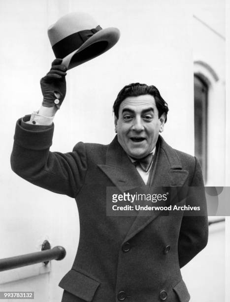 Italian opera singer tenor Tito Schipa , of the Chicago Civic Opera Company, waves from the deck of the SS Homeric upon his arrival, New York, New...