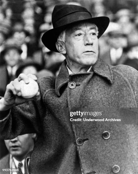 View of American baseball commissioner Kenesaw Mountain Landis as he throws out the first baseball of the season in the opening game , Chicago,...