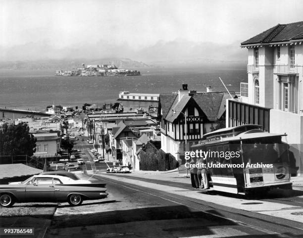View, along Hyde Street , on Russian Hill, San Francisco, California, November 1965. At right, a Powell and Hyde Street cable car descends towards...