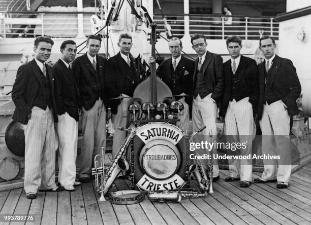 Portrait of members of the Troubadors band as they pose on the deck of Italian-based, Cosulich Line cruise ship, MS Saturnia, Trieste, Italy, 1927.