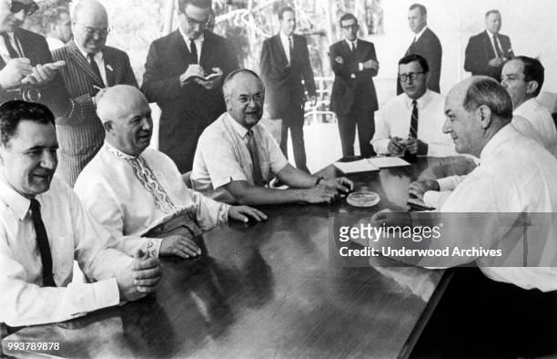 View of Soviet Premier Nikita Krushchev as he sits across from US Secretary of State Dean Rusk after they had signed a limited nuclear test ban pact...