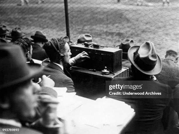 American sound engineer Eugene Grossman , of radio station WEAF, broadcasts the World Series from the Polo Grounds, New York, New York, October 11,...