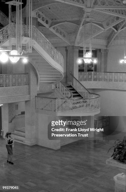 Rookery Building lobby from balcony with Frank Lloyd Wright's 1905 alterations, woman walking through lobby, Chicago, Illinois, undated.