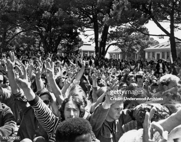 View of demonstrators, many making peace signs, during an anti-Vietnam War rally in People's Park, in front of the President's house at the...