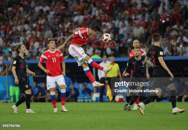 July 2018, Russia, Sotchi: Soccer: FIFA World Cup, Quarter Final: Russia vs Croatia Sotchi stadium. Russia's Fedor Smolov heads the ball next to...