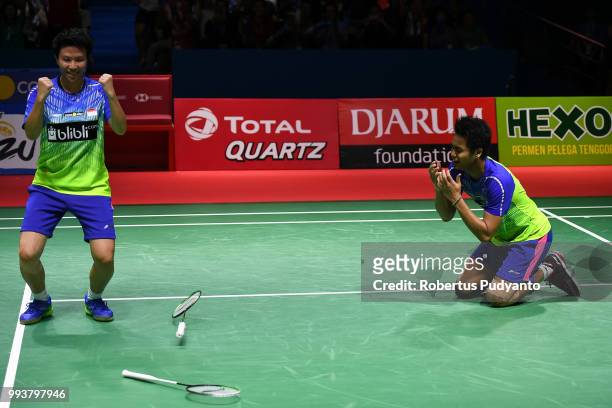 Gold medalist Tontowi Ahmad and Liliyana Natsir of Indonesia celebrate victory after beating Chan Peng Soon and Goh Liu Ying of Malaysia during the...