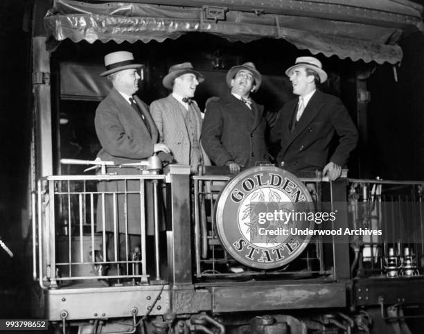 At LaSalle Station, Italian opera singer tenor Tito Schipa , of the Chicago Civic Opera Company, sings with three unidentified man on the rear...