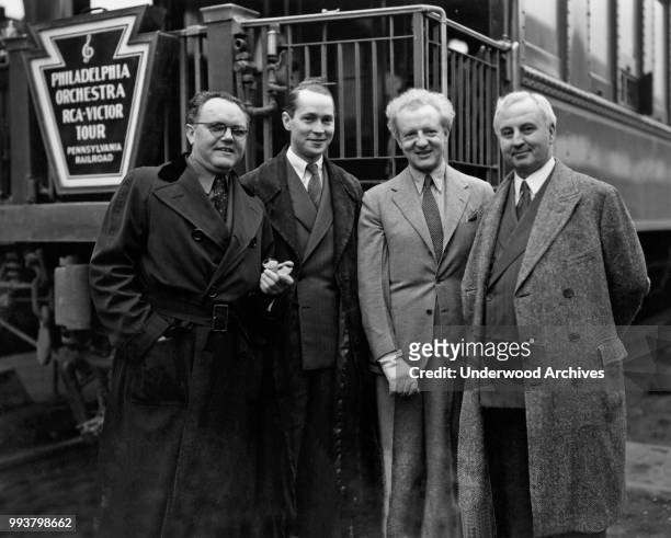 Portrait of, from left, American graphic designer and book publisher Merle Armitage , American actor Franchot Tone , English conductor Leopold...