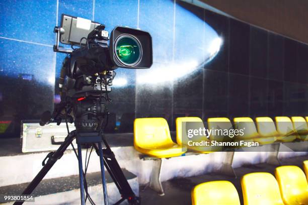 professional tv camera filming event in a stadium - disco ball foto e immagini stock