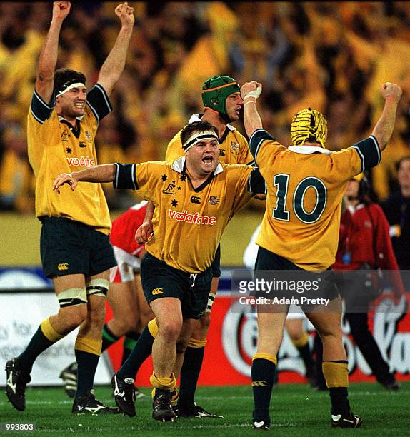 Wallabies players John Eales, Nick Stiles and Elton Flatley celebrate after victory over the British and Irish Lions, in the third Test Match between...