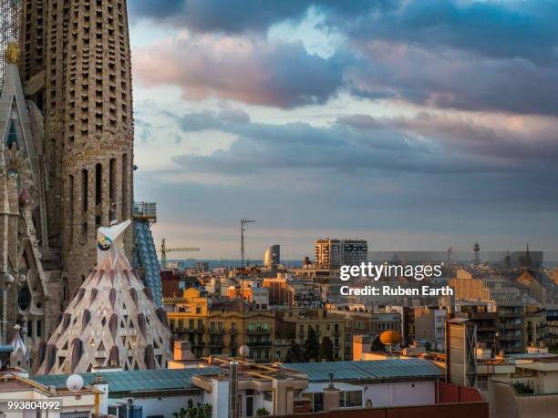 view of barcelona skyline with the sagrada familia in the foreground at the left side - familia stock pictures, royalty-free photos & images