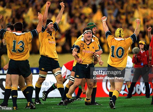 Wallabies players John Eales, Nick Stiles and Elton Flatley celebrate after victory over the British and Irish Lions, in the third Test Match between...