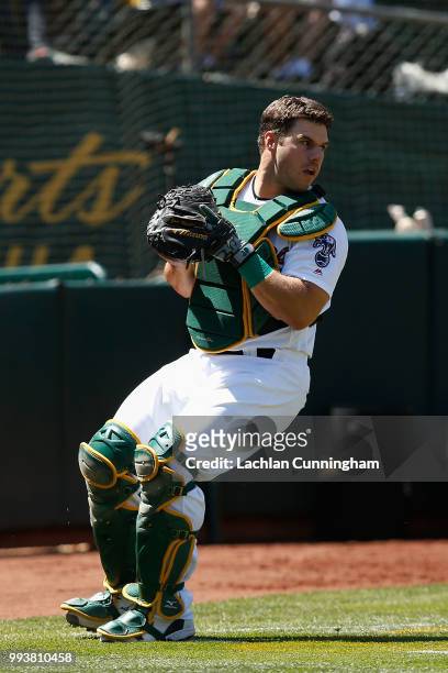 Josh Phegley of the Oakland Athletics catches a ball in foul territory to get the out of Travis Jankowski of the San Diego Padres in the eighth...