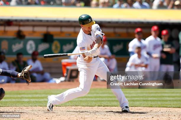 Stephen Piscotty of the Oakland Athletics hits a two-run double in the eighth inning against the San Diego Padres in at Oakland Alameda Coliseum on...