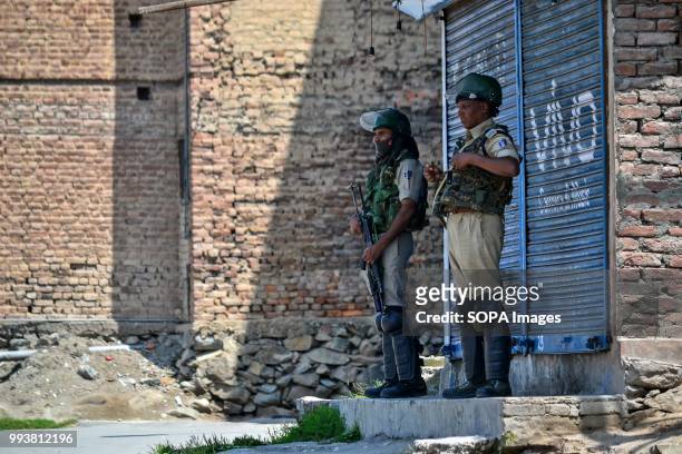 Indian paramilitary troopers stand alert during restrictions imposed on the eve of the second death anniversary of the rebel commander Burhan...