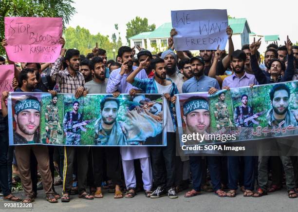 Kashmiri students shout pro- freedom slogans during a protest rally on the eve of the second death anniversary of the rebel commander Burhan Muzaffar...