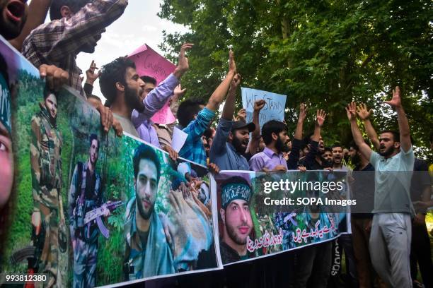 Kashmiri students shout pro- freedom slogans during a protest rally on the eve of the second death anniversary of the rebel commander Burhan Muzaffar...