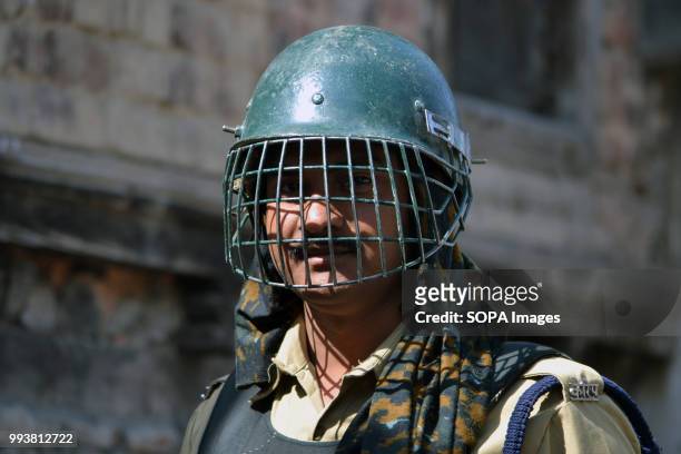 Indian paramilitary trooper stands guard during a curfew restrictions, on the second death anniversary of Burhan Muzaffar Wani a young rebel...