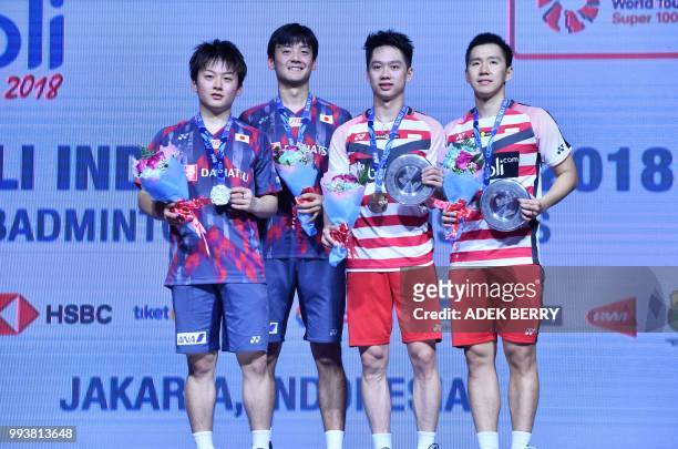 Takuto Inoue and Yuki Kaneko of Japan, Kevin Sanjaya Sukamuljo and Marcus Fernaldi Gideon of Indonesia pose after the men's doubles badminton final...