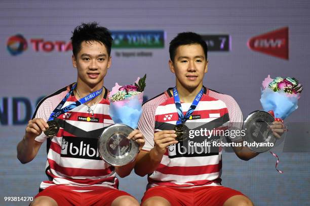 Gold medalists Marcus Fernaldi Gideon and Kevin Sanjaya Sukamuljo of Indonesia celebrate victory after beating Takuto Inoue and Yuki Kaneko of Japan...