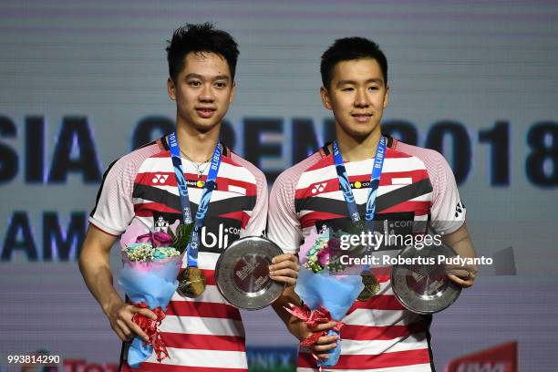 Gold medalists Marcus Fernaldi Gideon and Kevin Sanjaya Sukamuljo of Indonesia celebrate victory after beating Takuto Inoue and Yuki Kaneko of Japan...