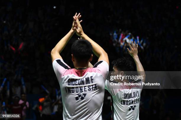 Gold medalists Marcus Fernaldi Gideon and Kevin Sanjaya Sukamuljo of Indonesia celebrate victory after beating Takuto Inoue and Yuki Kaneko of Japan...