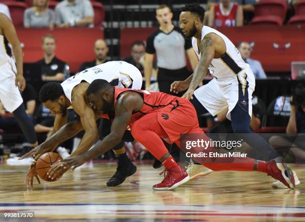 Chasson Randle of the New Orleans Pelicans and Giddy Potts of the Toronto Raptors fight for a loose ball during the 2018 NBA Summer League at the...
