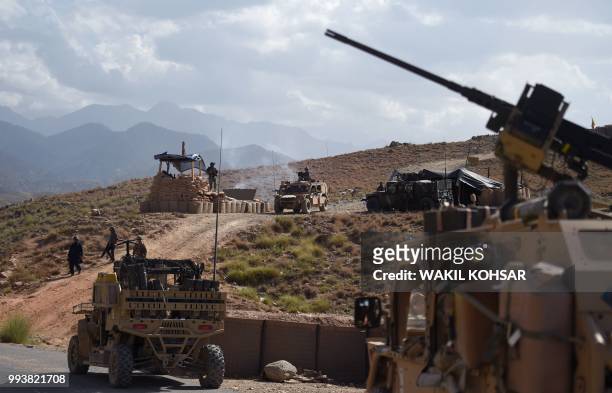 In this photo taken on July 7 US Army from NATO and Afghan commando forces are pictures in a checkpoint during a patrol against Islamic State...