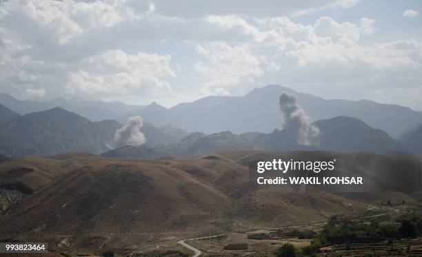 In this photo taken on July 7 smoke rises after an air strike bomb on Islamic State militants positions in a checkpoint at the Deh Bala district in...