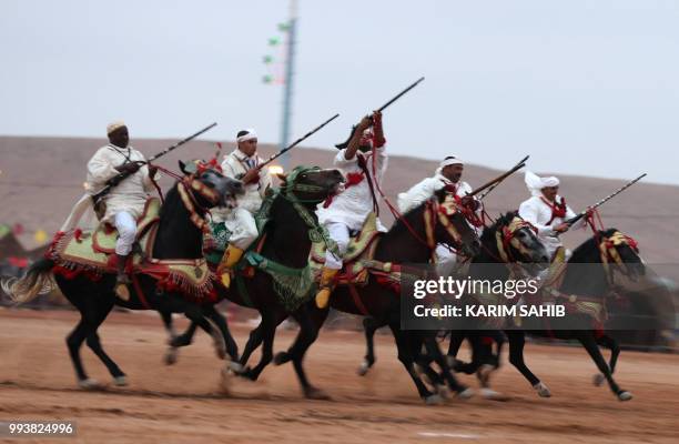 Horsemen ride in a choreographed cavalry charge in a fantasia during the 14th Tan-Tan Moussem Berber festival on July 8, 2018 in the western Moroccan...
