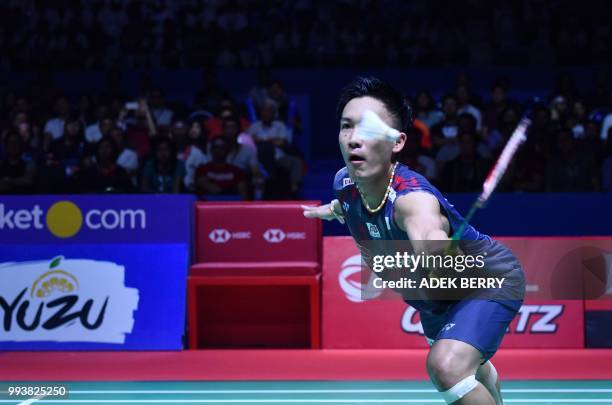 Kento Momota of Japan plays a return against Viktor Axelsen of Denmark during the men's singles badminton final match at the Indonesia Open in...