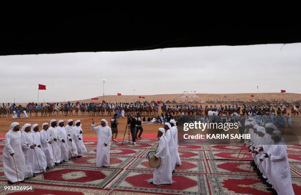 Emiratis perform traditional music and dance during a fantasia as part of the 14th Tan-Tan Moussem Berber festival on July 08, 2018 in the western...