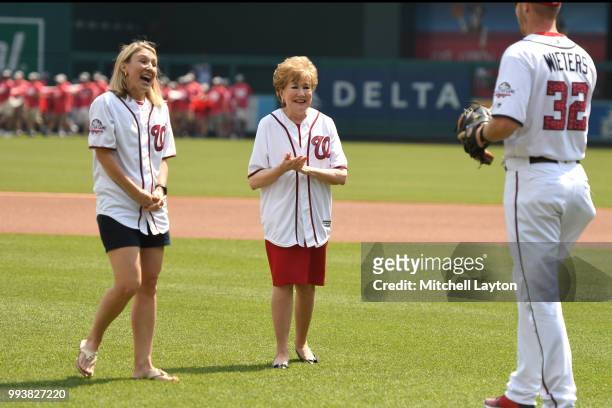Senator Elizabeth Dole joins Caregiver Megan Smith to throw out the first pitch to Matt Wieters of the Washington Nationals before a baseball game...