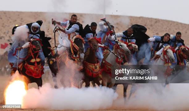 Horsemen ride in a choreographed cavalry charge in a fantasia during the 14th Tan-Tan Moussem Berber festival on July 8, 2018 in the western Moroccan...