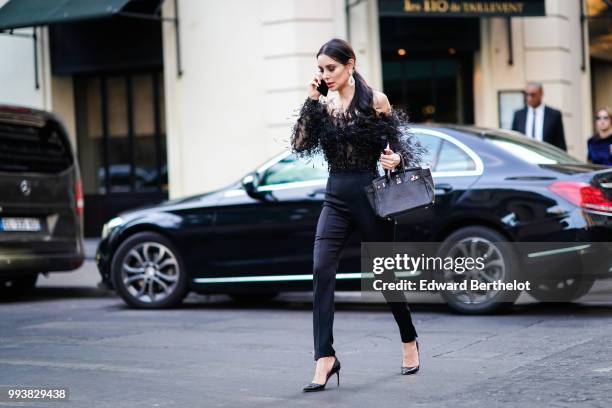 Deborah Hung wears a black lace mesh top, black jeans , outside Valentino, during Paris Fashion Week Haute Couture Fall Winter 2018/2019, on July 4,...