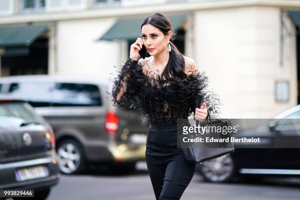 Deborah Hung wears a black lace mesh top, black jeans , outside Valentino, during Paris Fashion Week Haute Couture Fall Winter 2018/2019, on July 4,...