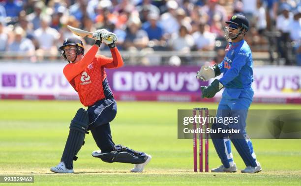 England batsman Jos Buttler hits out watched by MS Dhoni during the 3rd Vitality International T20 match between England and India at The Brightside...