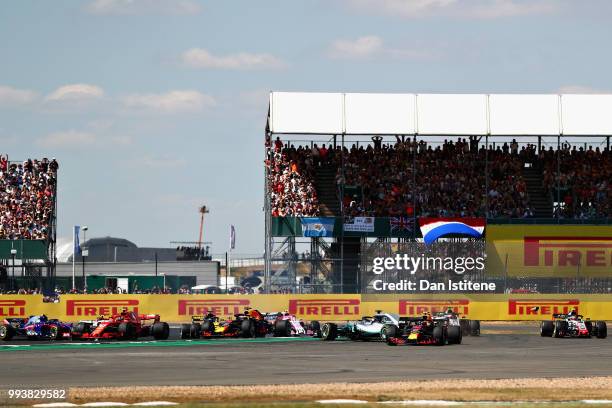 Max Verstappen of the Netherlands driving the Aston Martin Red Bull Racing RB14 TAG Heuer runs wide as Lewis Hamilton of Great Britain driving the...