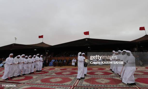 Emiratis perform traditional music and dance during a fantasia as part of the 14th Tan-Tan Moussem Berber festival on July 08, 2018 in the western...