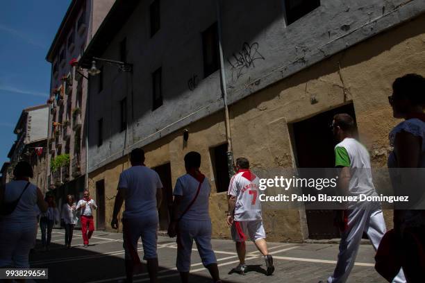 Revellers walk the streets in the old town on the third day of the San Fermin Running of the Bulls festival on July 8, 2018 in Pamplona, Spain. The...