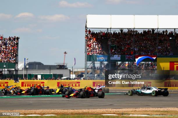 Max Verstappen of the Netherlands driving the Aston Martin Red Bull Racing RB14 TAG Heuer runs wide as Lewis Hamilton of Great Britain driving the...