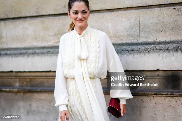Sofia Sanchez de Betak wears a white dress , outside Valentino, during Paris Fashion Week Haute Couture Fall Winter 2018/2019, on July 4, 2018 in...