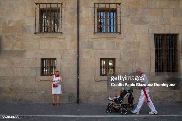 Revellers walk the streets in the old town on the third day of the San Fermin Running of the Bulls festival on July 8, 2018 in Pamplona, Spain. The...