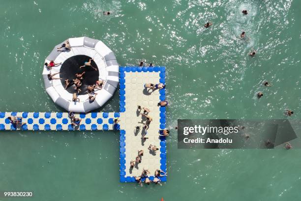 Drone photo shows that people swim and sunbathe during a hot summer day at newly opened public beach on the shore of Van Lake on July 8, 2018 in Van,...