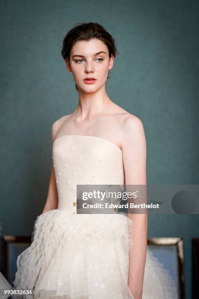 Model wears a white lace dress, after the Ulyana Sergeenko Haute Couture Fall Winter 2018/2019 show as part of Paris Fashion Week on July 3, 2018 in...