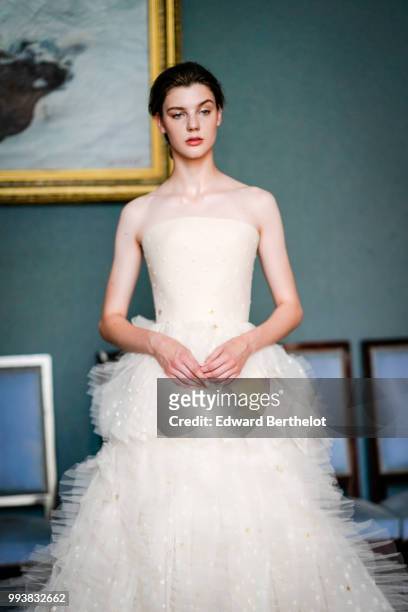 Model wears a white lace dress, after the Ulyana Sergeenko Haute Couture Fall Winter 2018/2019 show as part of Paris Fashion Week on July 3, 2018 in...