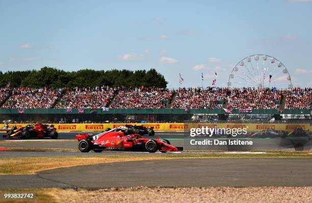 Sebastian Vettel of Germany driving the Scuderia Ferrari SF71H leads the field during the Formula One Grand Prix of Great Britain at Silverstone on...