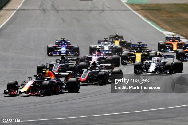 Daniel Ricciardo of Australia driving the Aston Martin Red Bull Racing RB14 TAG Heuer leads Kevin Magnussen of Denmark driving the Haas F1 Team VF-18...